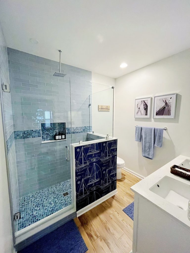Bathroom with a glass-enclosed tile shower and blue patterned tile